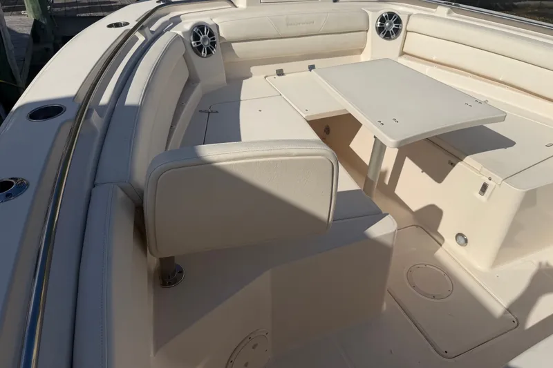 Slide: The Image of 2021 Grady-White Canyon 326 boat interior with seating and table setup. - 59