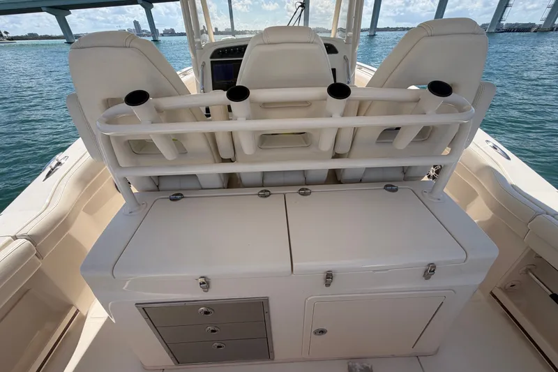 Slide: The Image of 2021 Grady-White Canyon 326 boat interior with rod holders and storage compartments. - 92