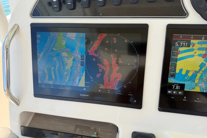 Slide: The Image of Garmin navigation screens on a 2021 Grady-White Canyon 326 boat dashboard. - 55