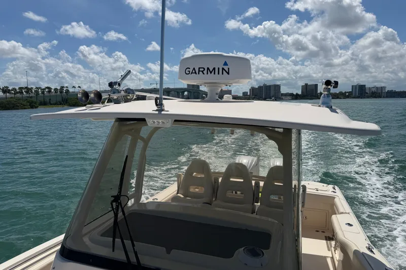 Slide: The Image of 2021 Grady-White Canyon 326 boat cruising on water under a sunny sky. - 118