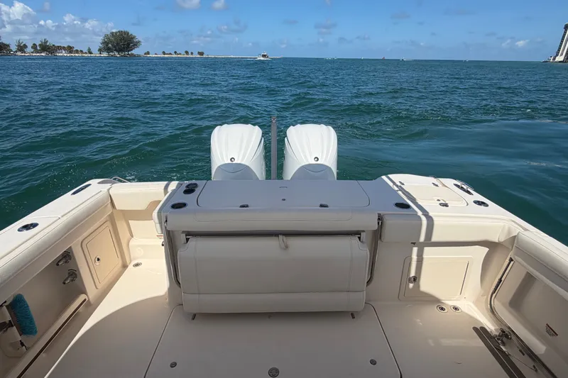 Slide: The Image of 2021 Grady-White Canyon 326 boat on open water, featuring dual engines and spacious deck. - 98