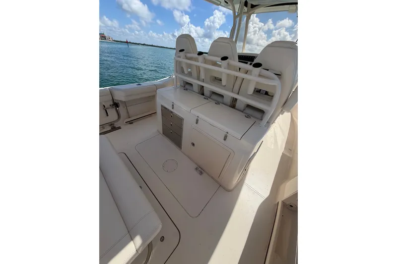 Slide: The Image of 2021 Grady-White Canyon 326 boat interior with seating and storage, on a sunny day. - 88