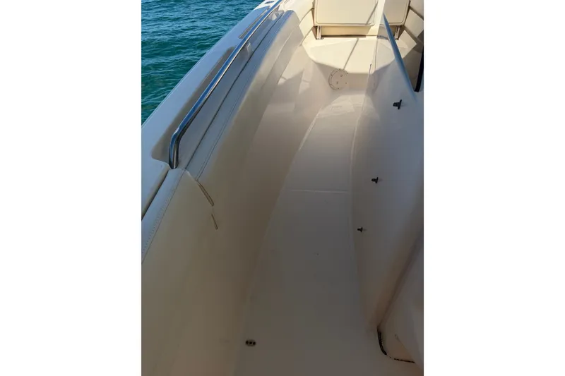 Slide: The Image of 2021 Grady-White Canyon 326 boat deck with stainless steel railing, on calm water. - 80