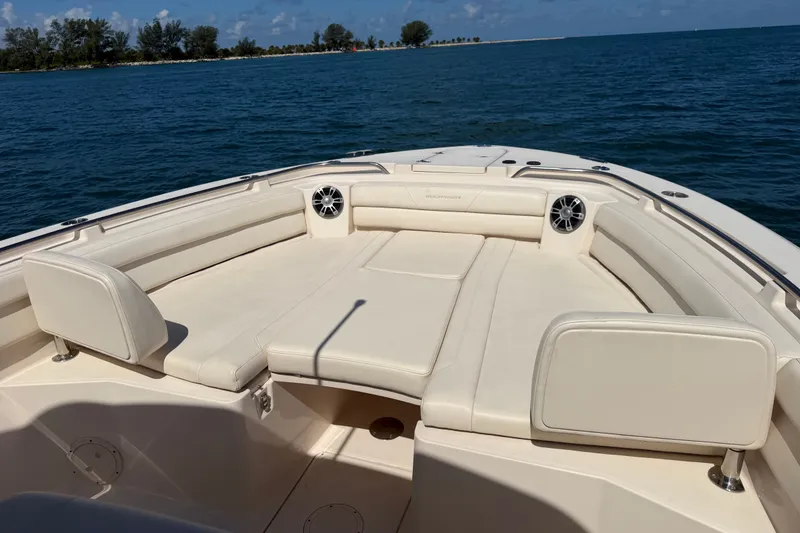 Slide: The Image of 2021 Grady-White Canyon 326 boat interior with cushioned seating on open water. - 78