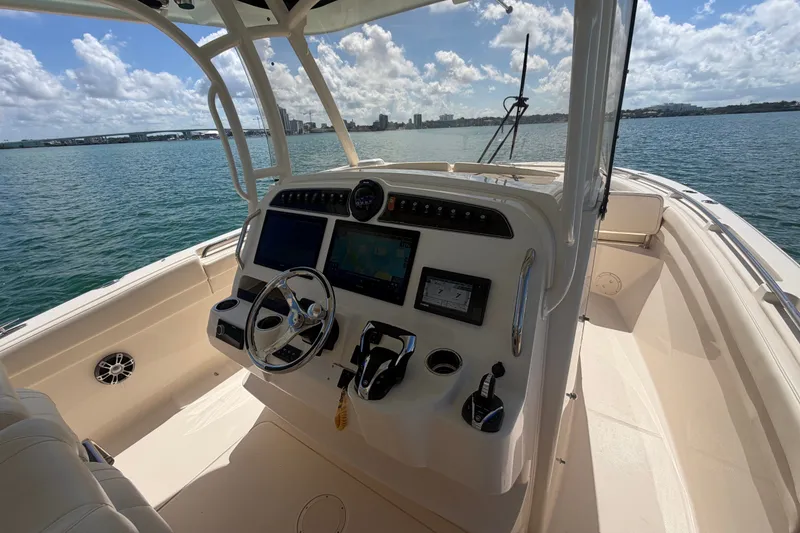 Slide: The Image of 2021 Grady-White Canyon 326 boat helm with modern controls and ocean view. - 85
