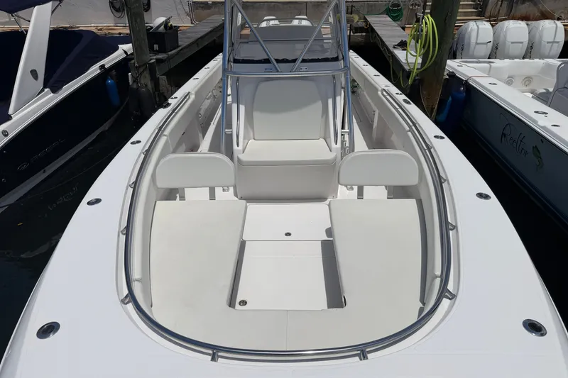 Slide: The Image of 2013 Fountain 34 Center Console boat docked, showcasing spacious seating and sleek design. - 29