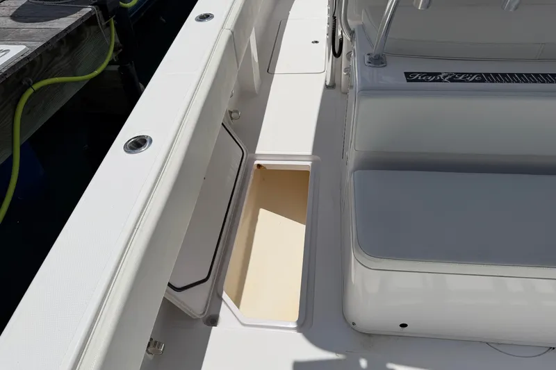 Slide: The Image of 2013 Fountain 34 Center Console boat interior with open storage compartment. - 46
