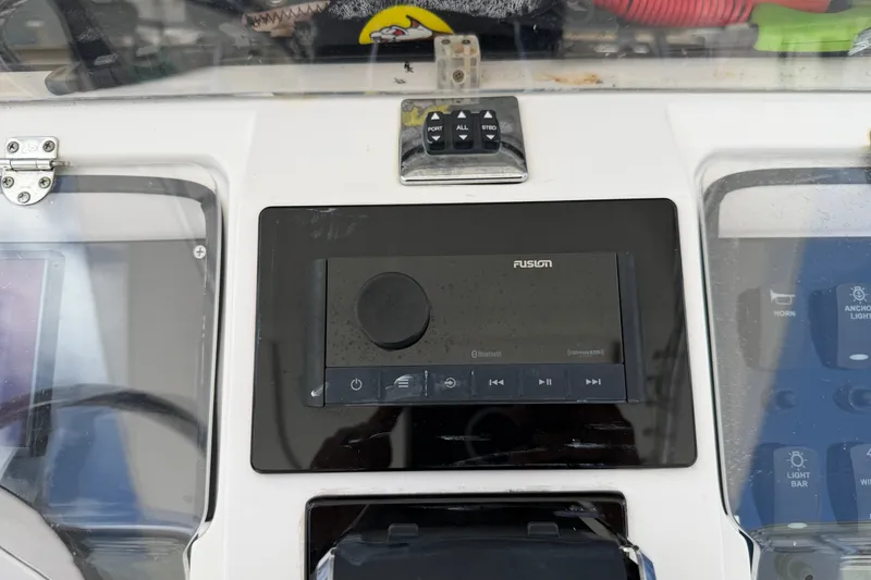 Slide: The Image of Center console of 2013 Fountain 34, featuring Fusion Bluetooth audio system. - 55