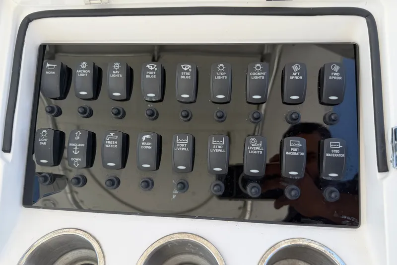 Slide: The Image of Control panel of a 2013 Fountain 34 Center Console boat with labeled switches. - 19
