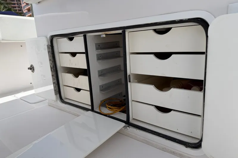Slide: The Image of Storage compartment with drawers on a 2013 Fountain 34 Center Console boat. - 50