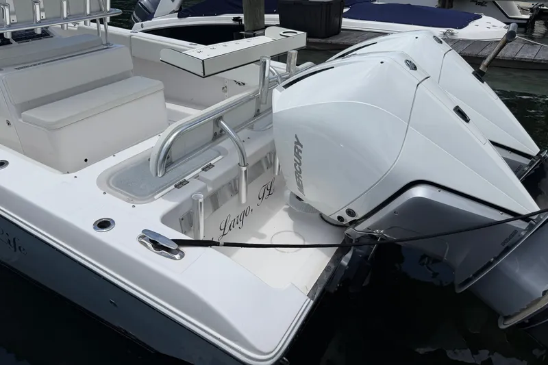 Slide: The Image of 2013 Fountain 34 Center Console boat with twin Mercury engines docked. - 57