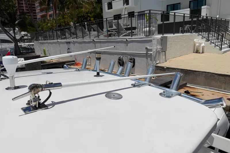 Slide: The Image of 2013 Fountain 34 Center Console boat deck with antennas and rod holders. - 54