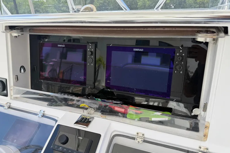 Slide: The Image of 2013 Fountain 34 Center Console with dual Simrad displays in the cockpit. - 16