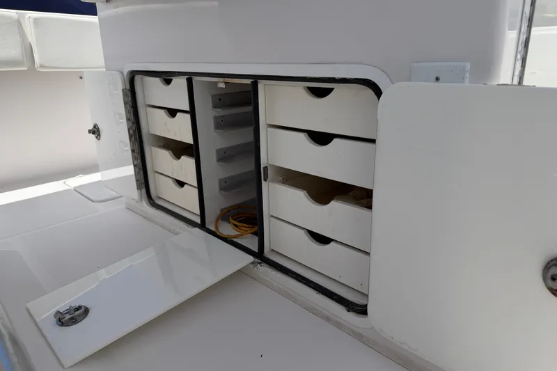 Slide: The Image of Storage compartments on a 2013 Fountain 34 Center Console boat, featuring organized drawers. - 49