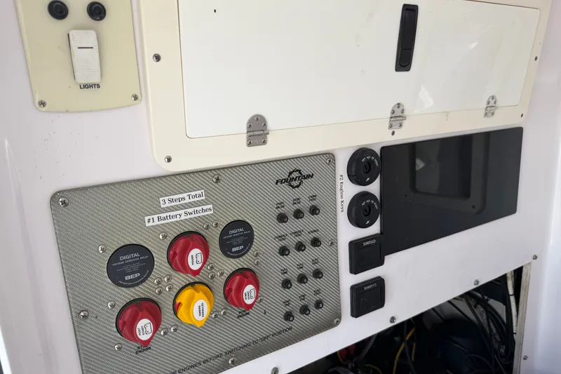 Slide: The Image of Control panel of a 2013 Fountain 34 Center Console boat with battery switches. - 24