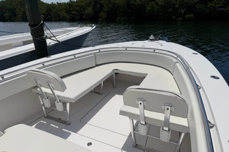 Slide: The Image of 2013 Fountain 34 Center Console boat with white seating, docked by the water. - 25
