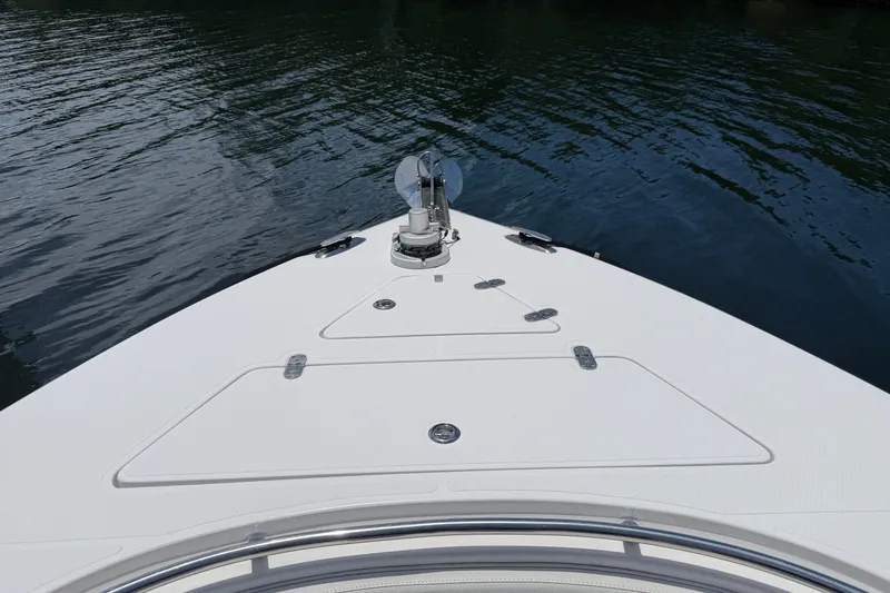 Slide: The Image of Bow of a 2013 Fountain 34 Center Console boat on calm water. - 27