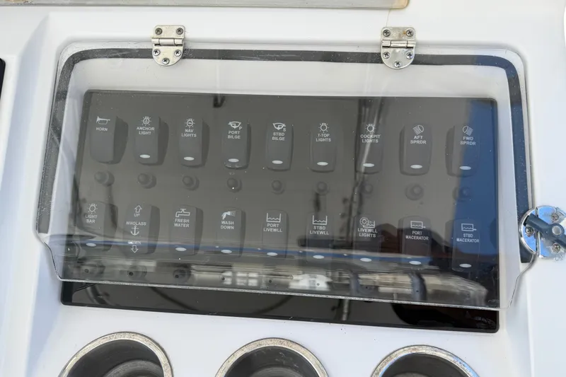 Slide: The Image of Control panel of a 2013 Fountain 34 Center Console boat with labeled switches. - 14