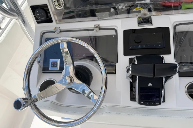 Slide: The Image of Steering console of 2013 Fountain 34 Center Console boat with modern controls. - 15