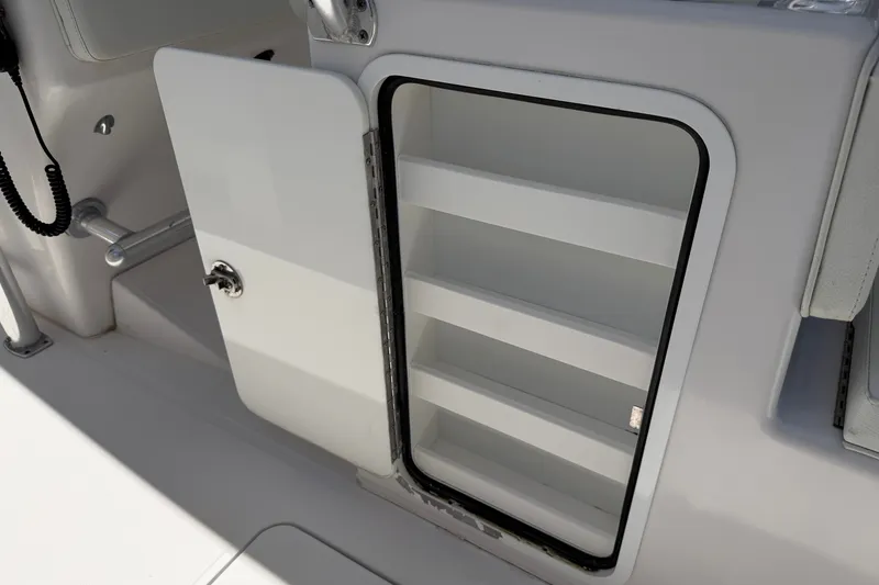 Slide: The Image of Open storage compartment on 2013 Fountain 34 Center Console boat. - 48