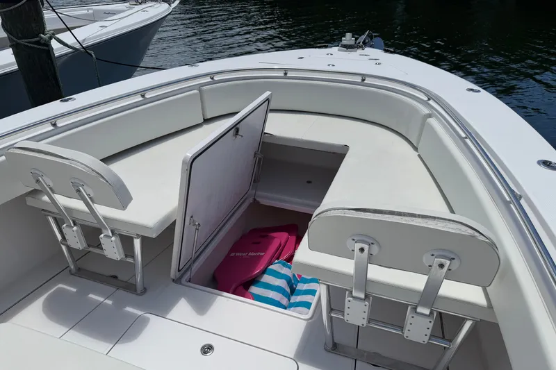 Slide: The Image of 2013 Fountain 34 Center Console boat with open storage compartment and seating. - 36