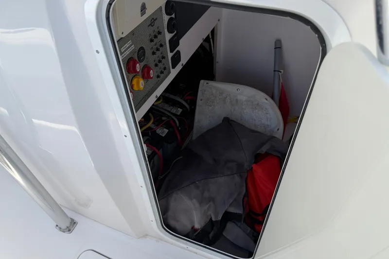 Slide: The Image of Storage compartment of a 2013 Fountain 34 Center Console boat with equipment and controls. - 23