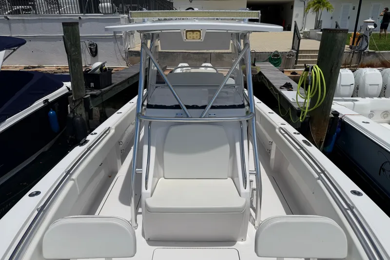 Slide: The Image of 2013 Fountain 34 Center Console boat docked, featuring sleek design and spacious seating. - 30