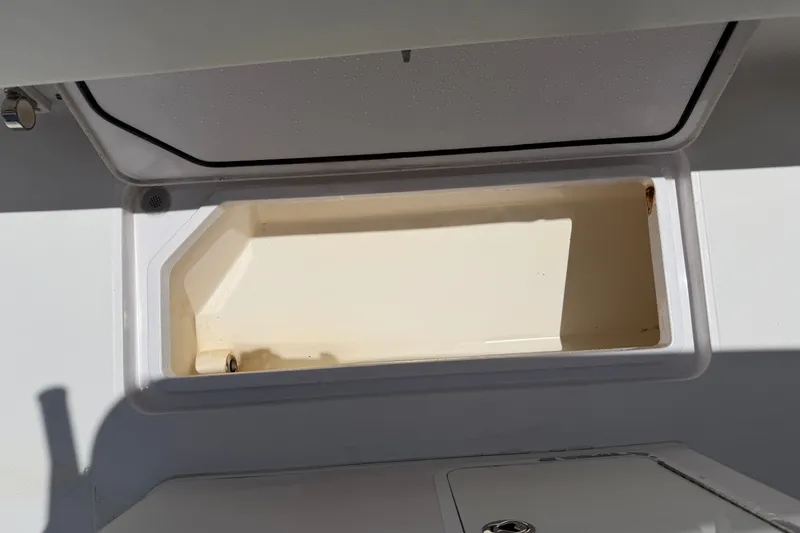 Slide: The Image of Open storage compartment on a 2013 Fountain 34 Center Console boat. - 47