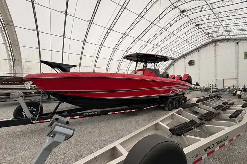 Slide: The Image of Red 2025 Statement 350 Open boat on trailer in covered storage facility. - 1