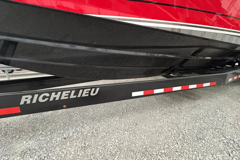 Slide: The Image of Red and black 2025 Statement 350 Open boat on Richelieu trailer. - 10
