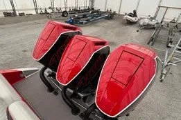 Slide: The Image of Red outboard motors on a 2025 Statement 350 Open boat in a storage area. - 3