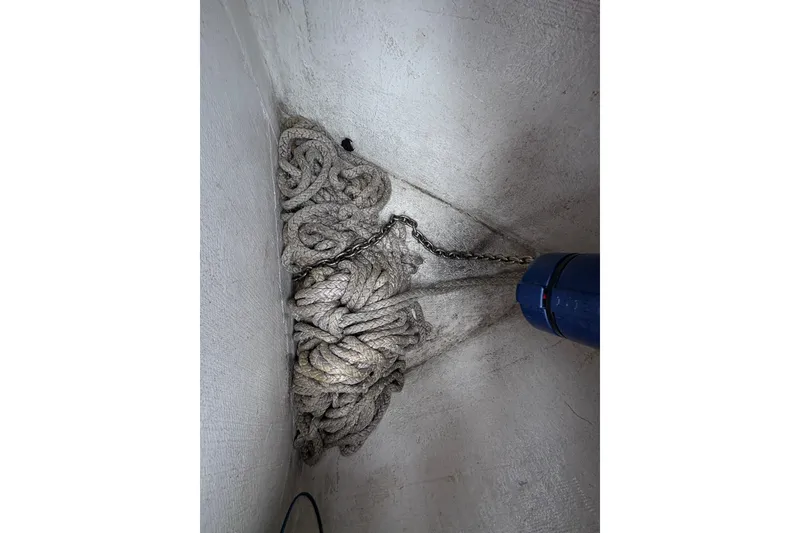 Slide: The Image of Coiled rope and chain in a compartment of a 2017 Statement 380 Open boat. - 36