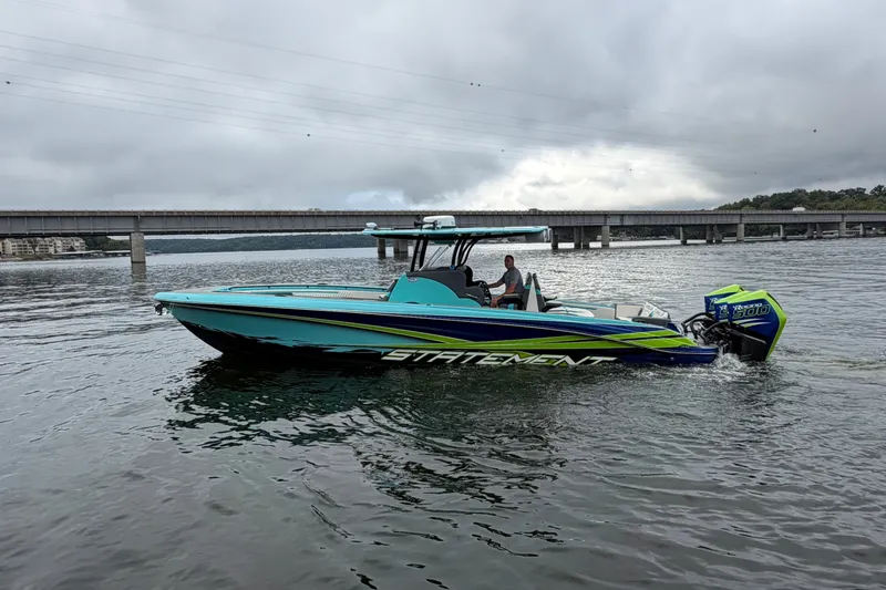 Slide: The Image of 2017 Statement 380 Open boat on water, vibrant colors, bridge in background. - 18