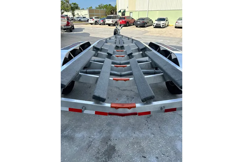 Slide: The Image of Boat trailer for 2017 Statement 380 Open, parked in a lot with cars. - 31
