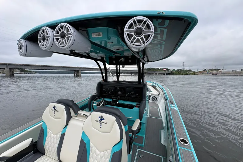 Slide: The Image of 2017 Statement 380 Open boat interior with speakers, seats, and water view. - 15