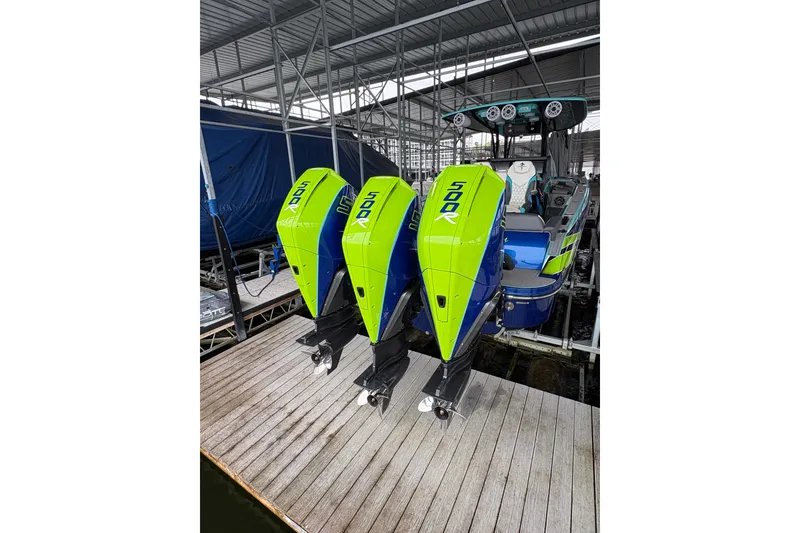 Slide: The Image of 2017 Statement 380 Open boat with triple 500R engines docked under a canopy. - 9
