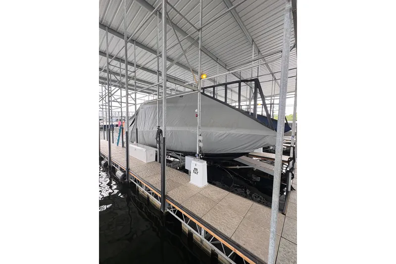 Slide: The Image of Covered 2017 Statement 380 Open boat docked under a metal canopy. - 33