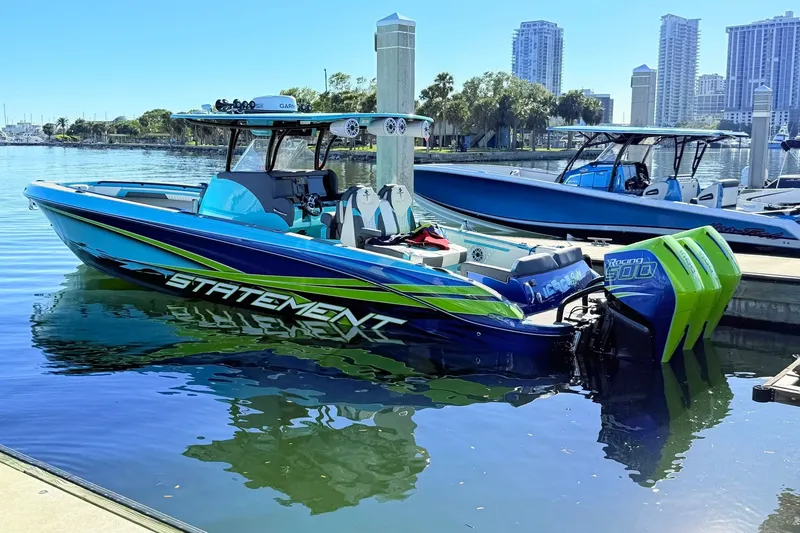 The Image of 2017 Statement 380 Open boat docked, featuring vibrant blue and green design with twin engines. - 0