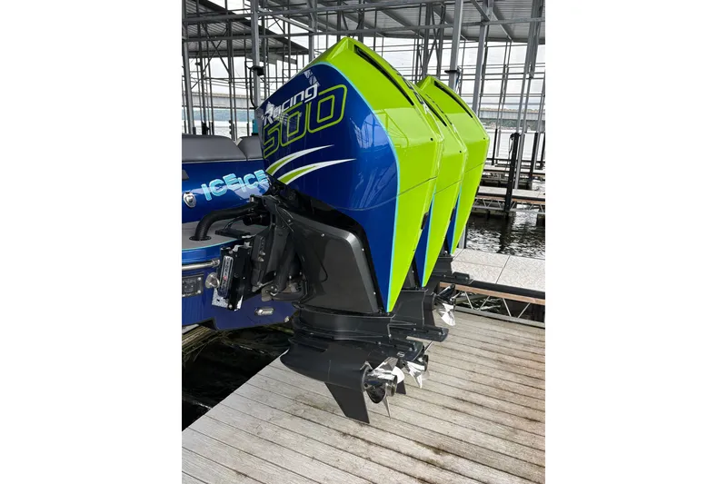 Slide: The Image of Three powerful outboard motors in blue and green at a boat dock. - 8