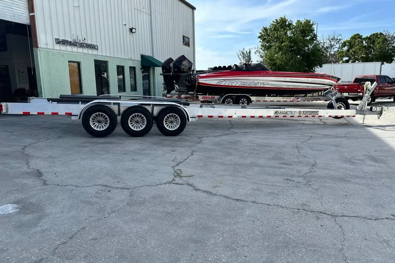 Slide: The Image of Trailer with 2017 Statement 380 Open boat parked outside a shipping facility. - 32