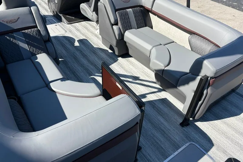 Slide: The Image of 2027 Bennington 22 M Open Fastback Quad Bench interior with luxurious gray seating. - 14