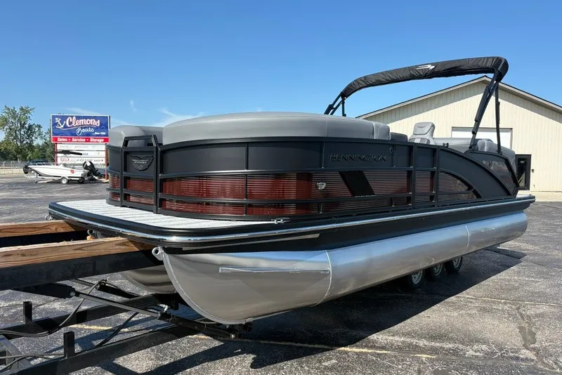 Slide: The Image of 2027 Bennington 22 M Open Fastback Quad Bench pontoon boat on trailer. - 1
