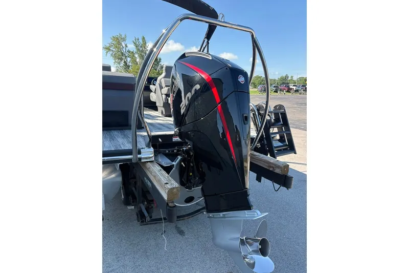 Slide: The Image of 2027 Bennington 22 M Open Fastback Quad Bench with powerful outboard motor. - 23