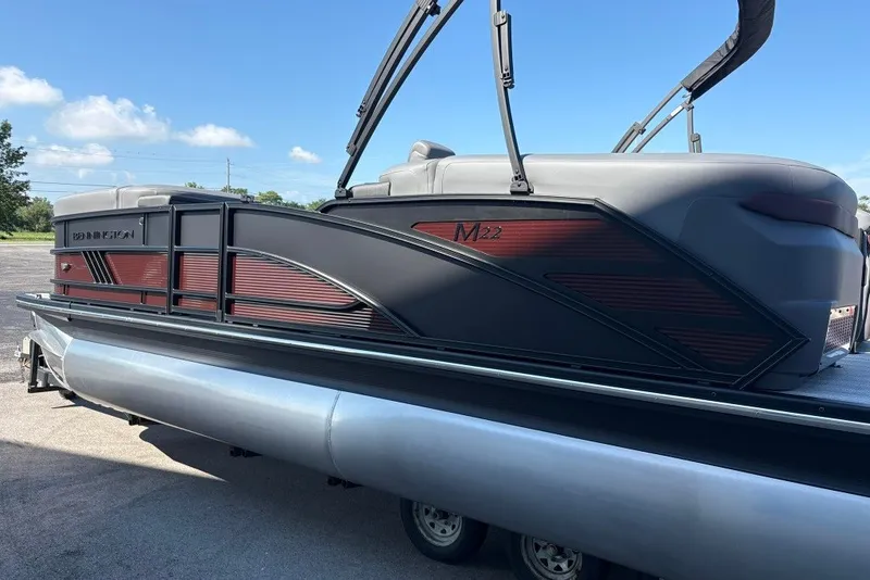 Slide: The Image of 2027 Bennington 22 M Open Fastback Quad Bench pontoon boat on trailer. - 6