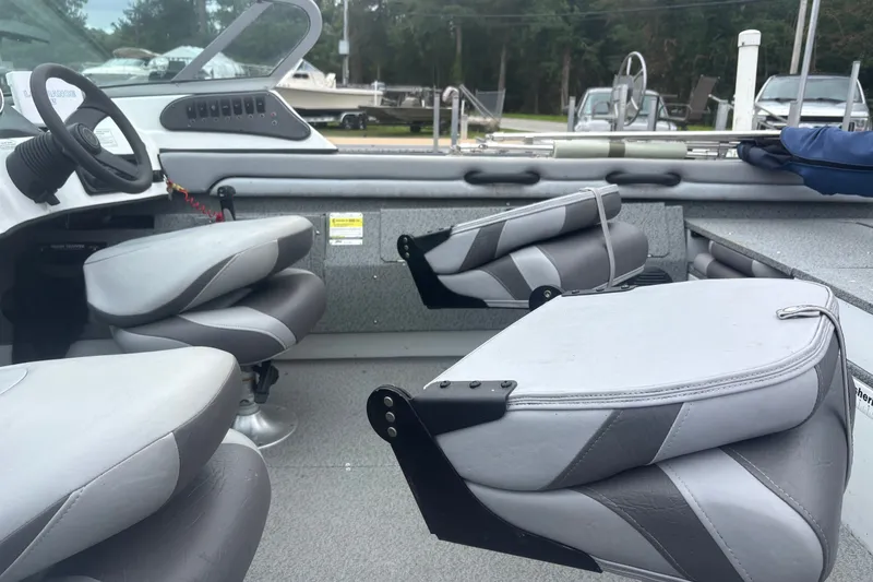 Slide: The Image of Interior of 2012 Polar Kraft Kodiak 180 WT boat with gray seating and steering console. - 8