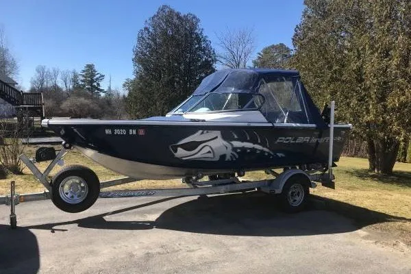 Slide: The Image of 2012 Polar Kraft Kodiak 180 WT boat on trailer, parked outdoors. - 1