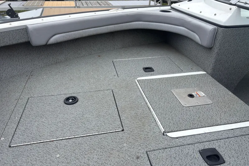 Slide: The Image of 2012 Polar Kraft Kodiak 180 WT boat interior with gray seating and storage compartments. - 9
