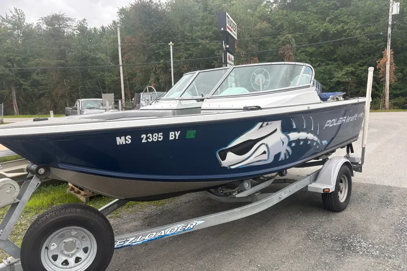 Slide: The Image of 2012 Polar Kraft Kodiak 180 WT boat on trailer, featuring sleek design and bold graphics. - 2