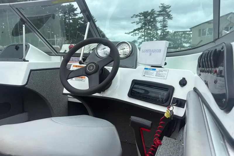 Slide: The Image of 2012 Polar Kraft Kodiak 180 WT boat dashboard with steering wheel and gauges. - 11