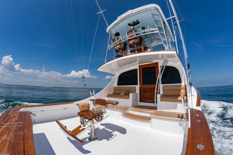 Slide: The Image of A 2004 Custom Carolina 61' Sportfisherman on the sea. Spacious deck with seating. - 8